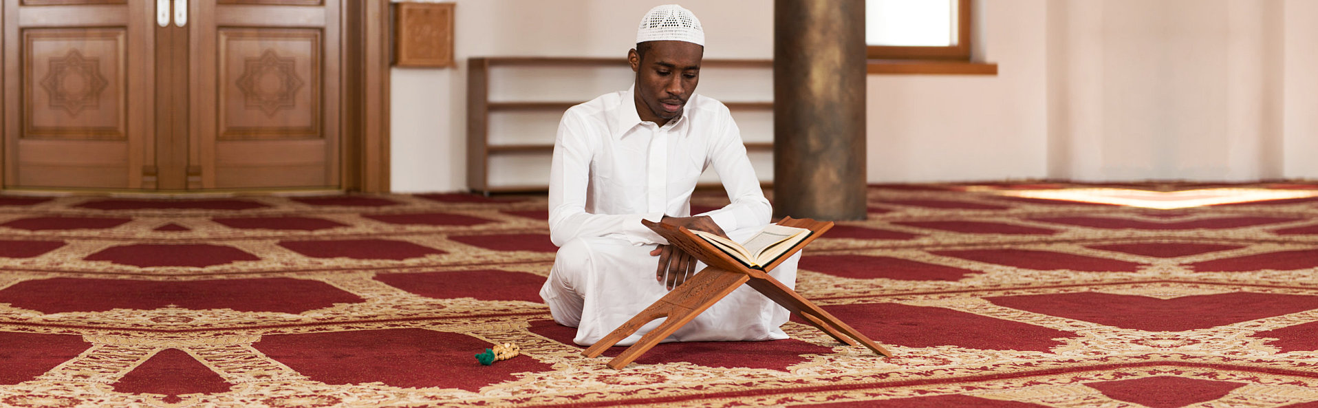 man reading holy islamic book